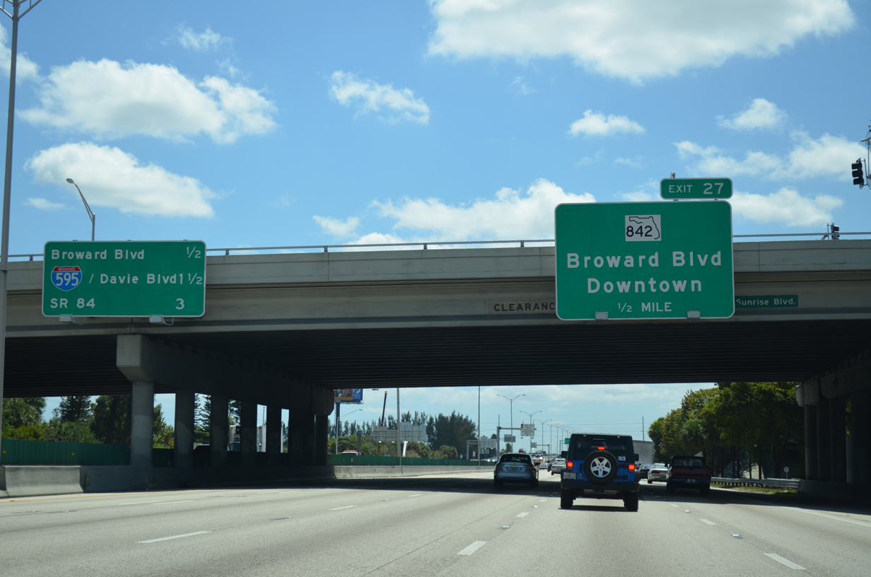 I-95 interchange traffic and overhead signs illustrating freeway ramp merging risks near Hallandale Beach